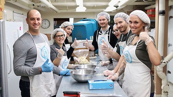 Group Volunteers giving thumbs up in Bissell's kitchen